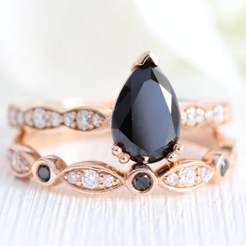 Halo - Style Women's Diamond Rings with a Center Diamond Surrounded by Smaller Diamonds in 18K GoldGrace Solitaire Black Diamond Ring Set w/ Pear Diamond and Bezel Wedding Band Halo - Style Women's Diamond Rings with a Center Diamond Surrounded by Smaller Diamonds in 18K GoldGrace Solitaire Black Diamond Ring Set w/ Pear Diamond and Bezel Wedding Band