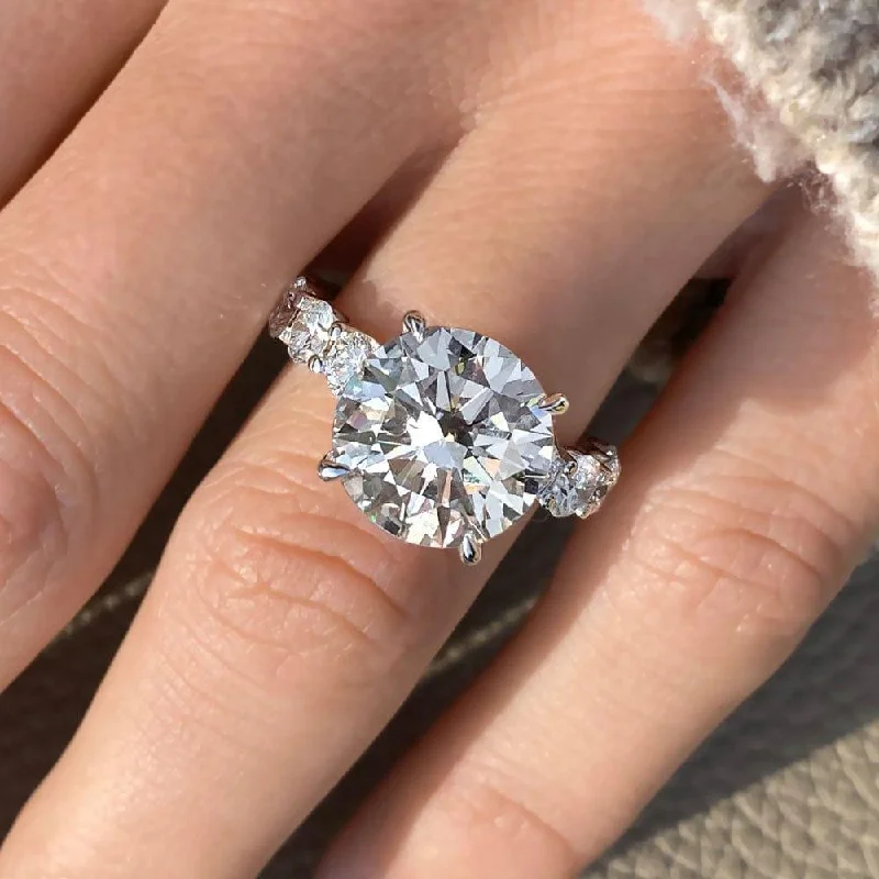 Men's Tanzanite Engagement Rings in Palladium with a Three - Stone Arrangement6.75 Carat Round Shape Shared Prong Moissanite Engagement Ring