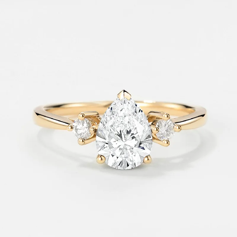 Channel - Set Women's Diamond Rings with Diamonds Securely Held in a Metal Groove for DurabilityPear Cut Lab Grown Diamond Three Stone Gold Ring